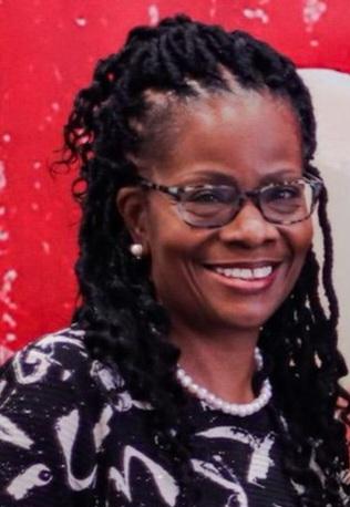 Smiling woman with glasses and braided hair